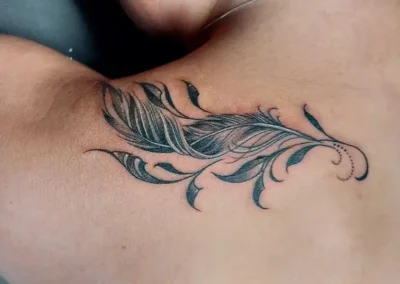 feather tattoo arm
